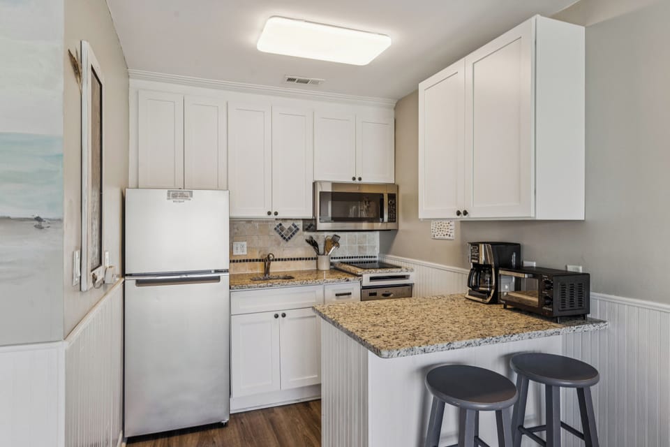 Kitchen with 2 barstools.