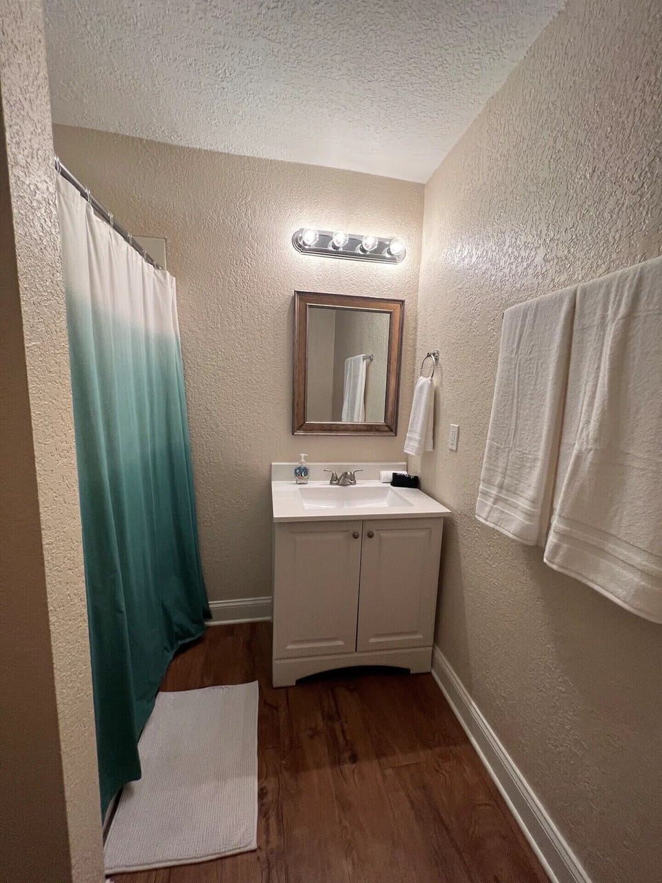 Over-sized walk in shower with shampoo, body wash and conditioner provided