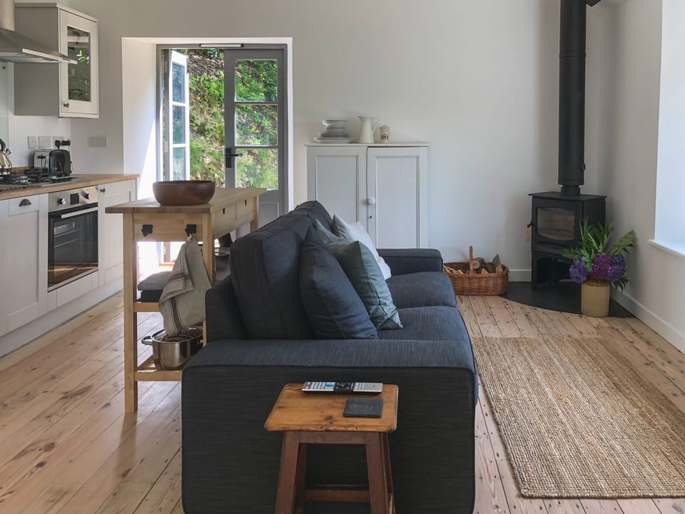 The living area with french doors onto roof terrace and back terrace