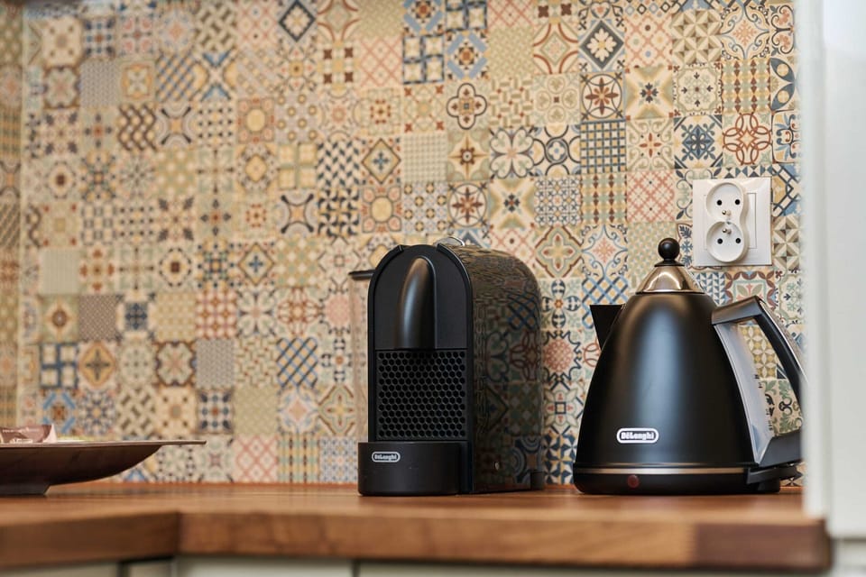 Close-up of kitchen essentials, including a coffee machine and electric kettle.

