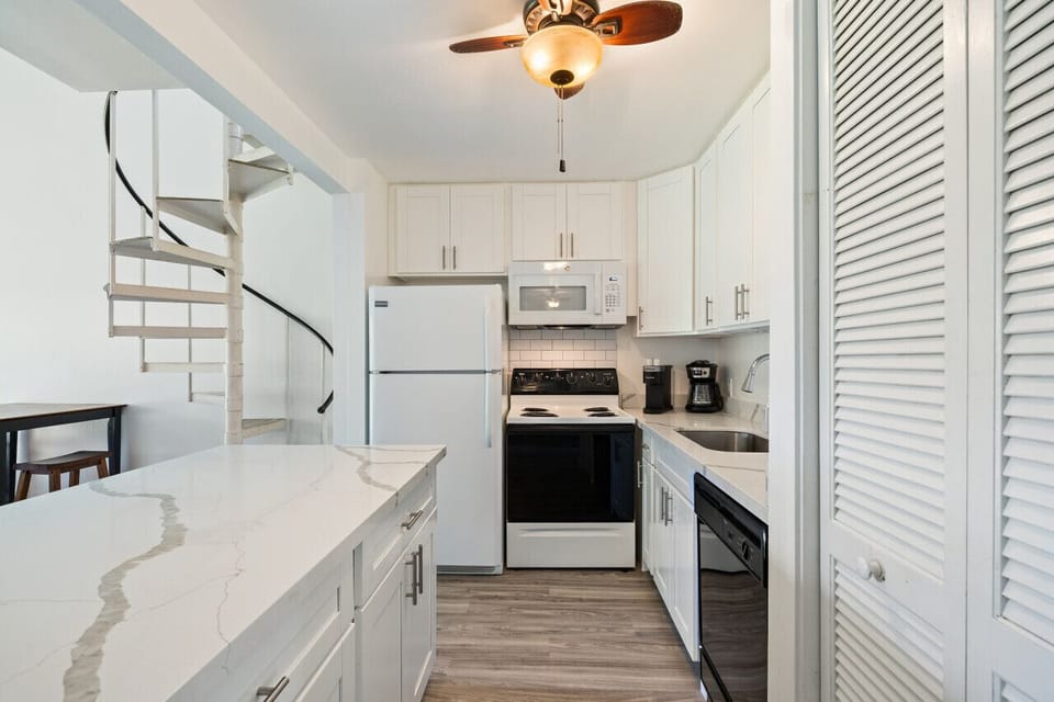 Sleek kitchen nook w/ modern appliances for quick meals.