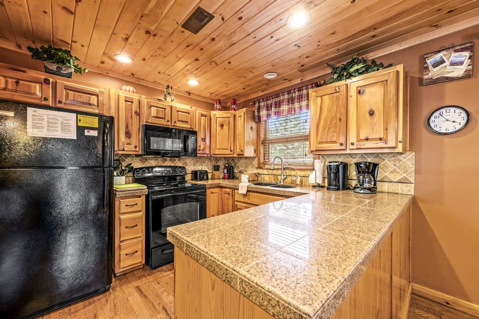 Kitchen with silverware, cookware, and plates provided