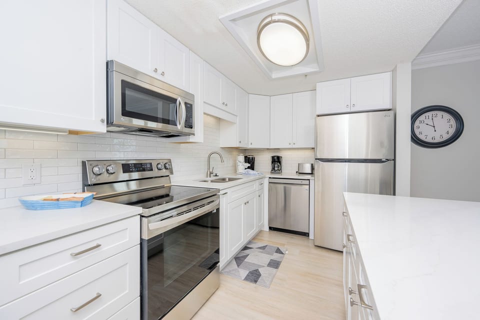 Prepare meals in this sleek kitchen featuring stainless steel appliances and elegant cabinetry for your culinary creations