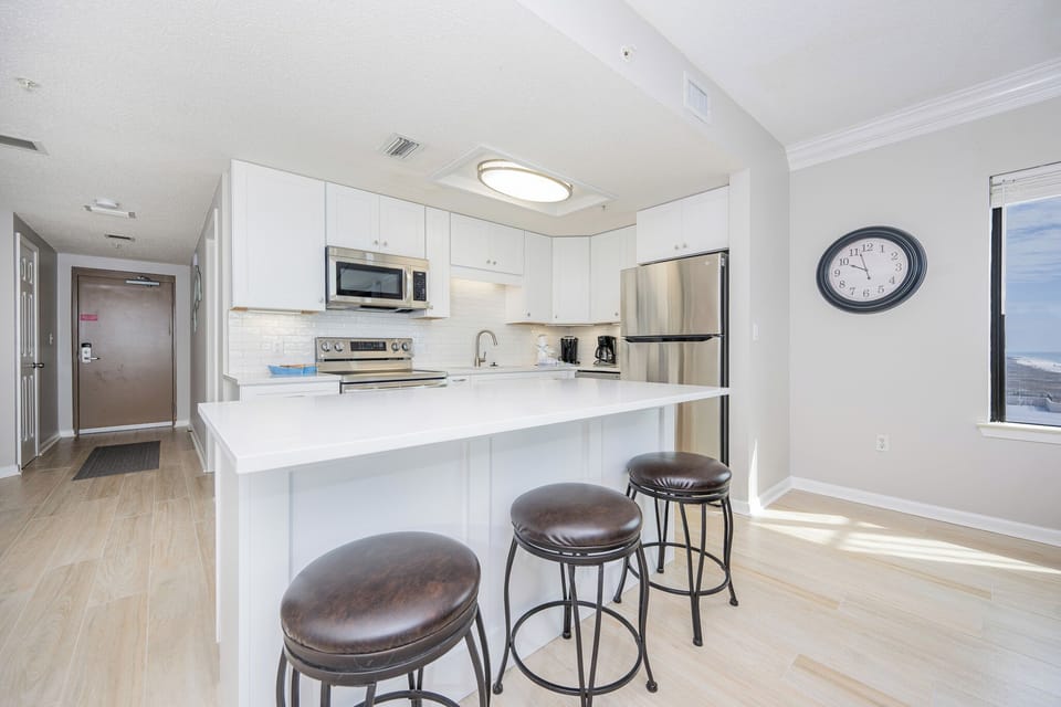 Gather at the sleek kitchen island, perfect for casual meals while enjoying the inviting atmosphere