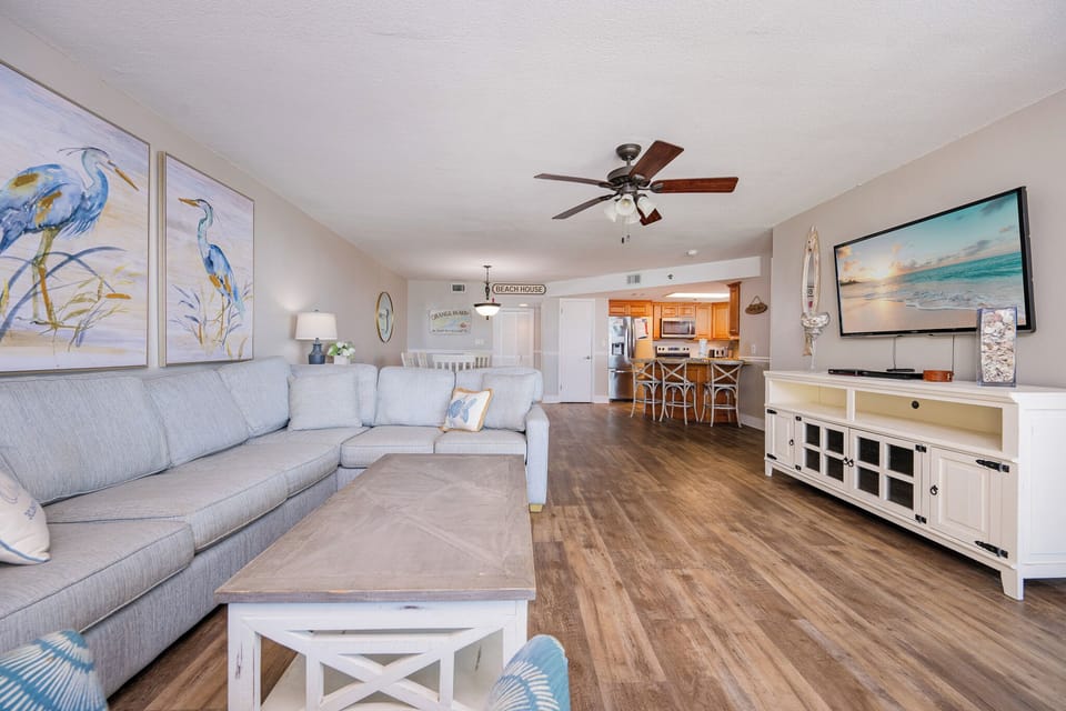 Relax on the cushioned sofa in the living room as you stream your favorite shows on the large TV