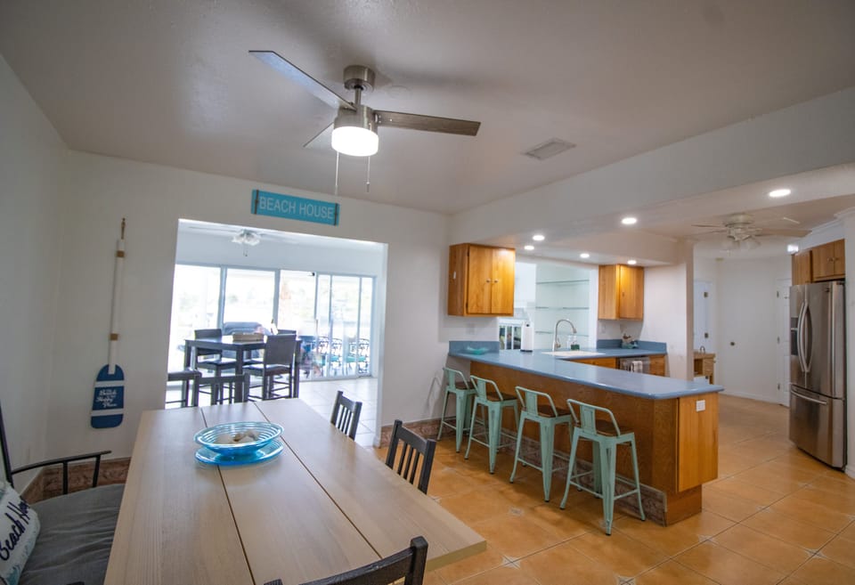View of the dining area, kitchen, and entertainment room.