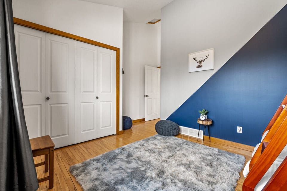 Third bedroom, located upstairs, with a single-over-double bunk bed and a closet.