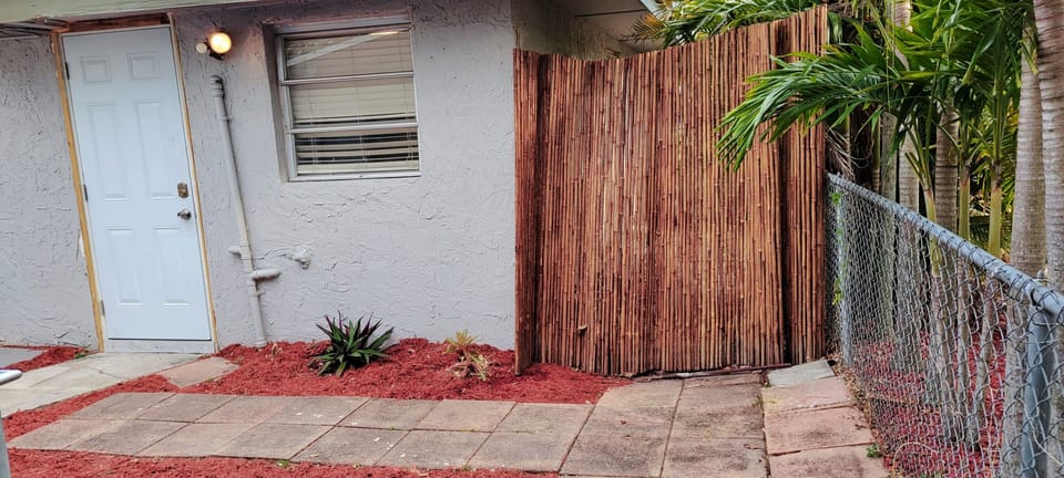 Tiny Home main entrance (right side in the back of the main house. follow pavers