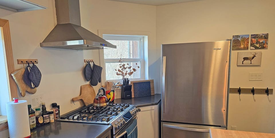 Features a full gas range, stone countertops, and a spacious island for cooking and gathering.