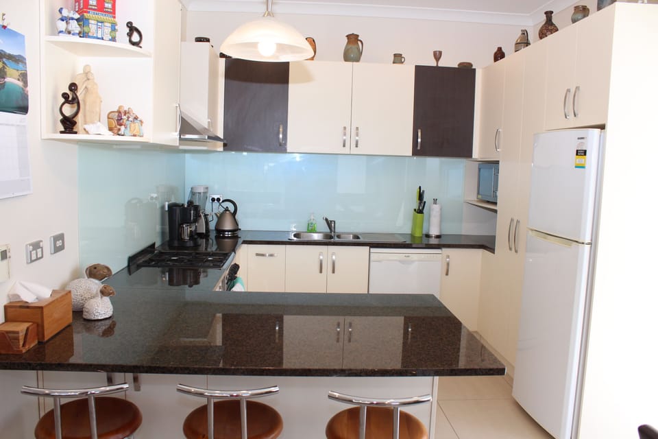 Modern kitchen with loads of pantry space. stove,fridge, dishwasher, wall oven  