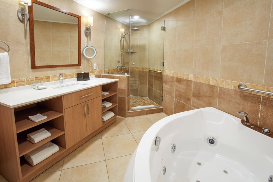 Refresh in the glass shower with bright vanity lighting.