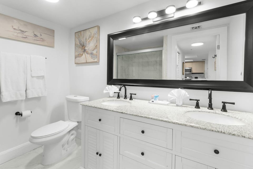 Refresh at the bright double vanity with spa-like lighting.