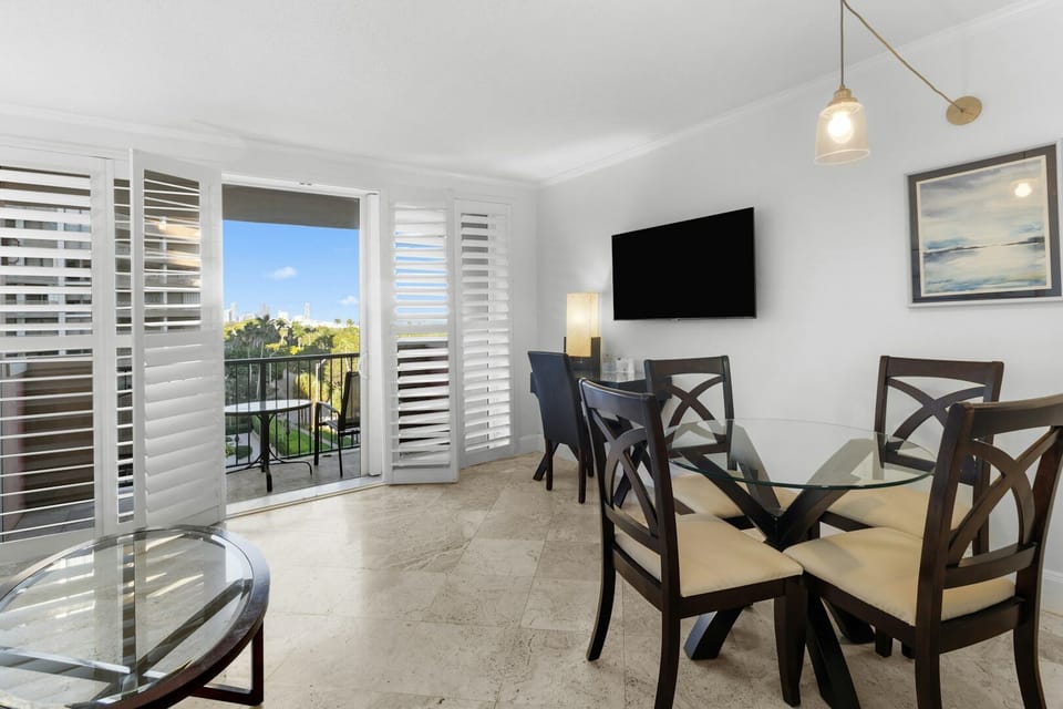 Savor sunny meals by the balcony doors with city views.