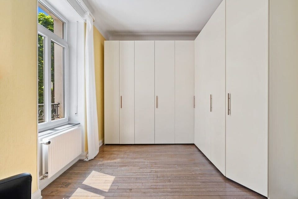 Spacious and serene bedroom with ample storage to keep your belongings organized.