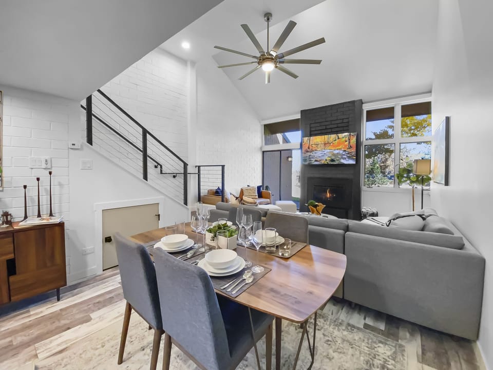 Enjoy our open-plan living and dining area. Relax by the fireplace on the comfortable sectional sofa, perfect for gathering and unwinding after a day of exploration.