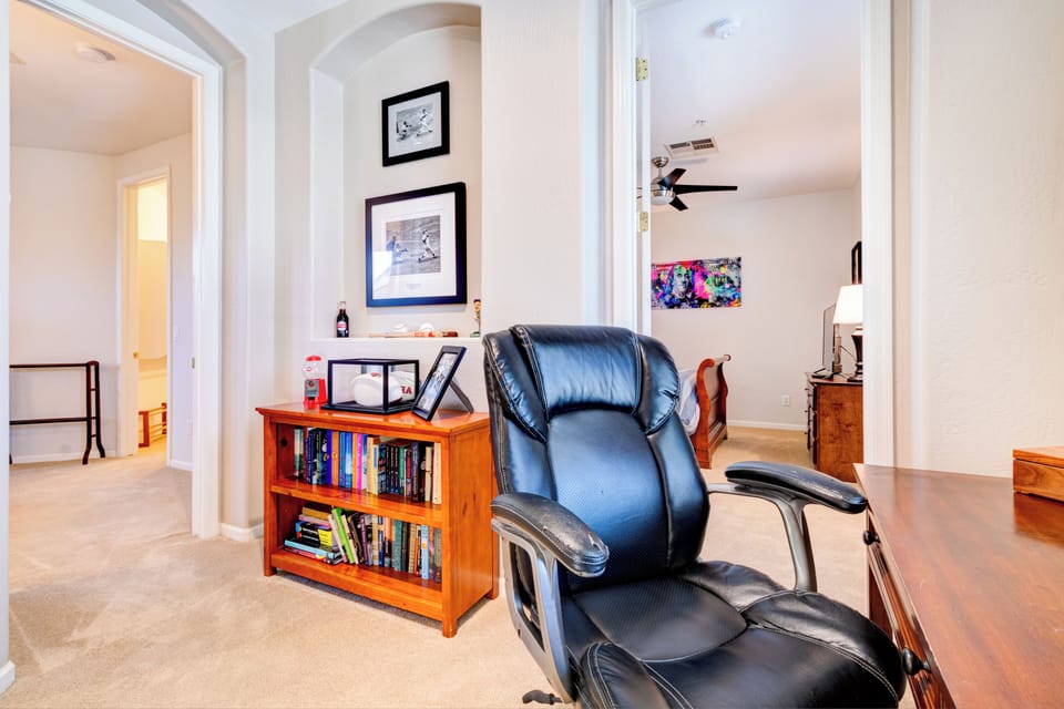 Small loft with office and well stocked bookcase.