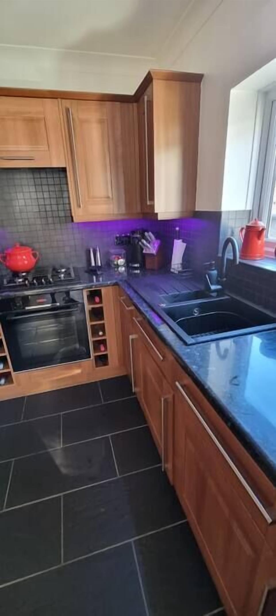 Kitchen with black resin sink.