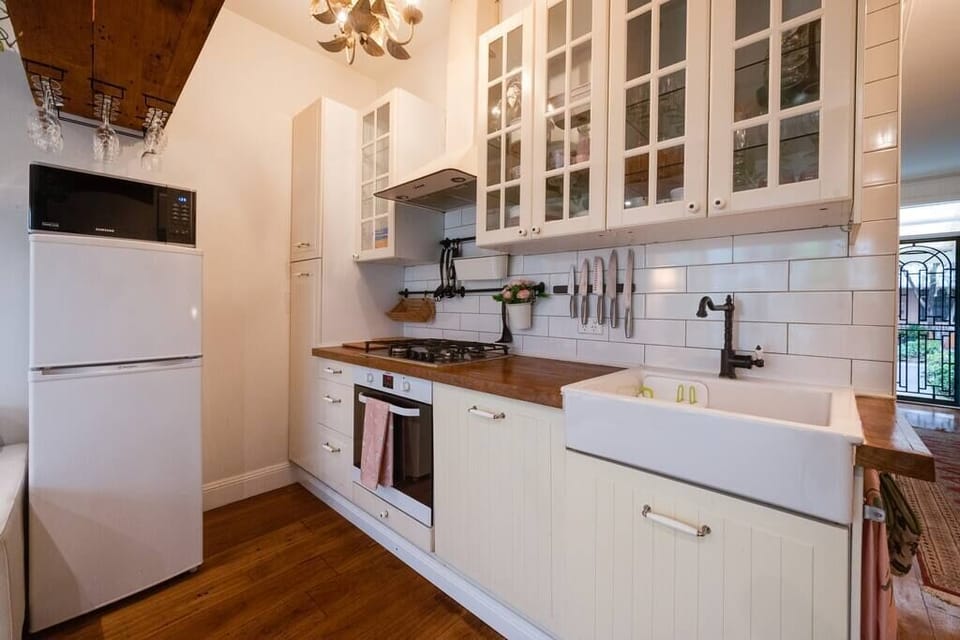 full equipped kitchen with gas stovetop, dishwasher, oven, wooden benchtops