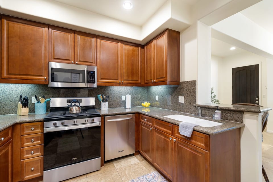 Five burner gas stove, oven, dishwasher, and microwave.