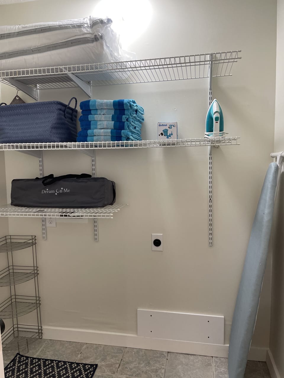 Storage closet with travel crib, ironing board, iron & electric air pump