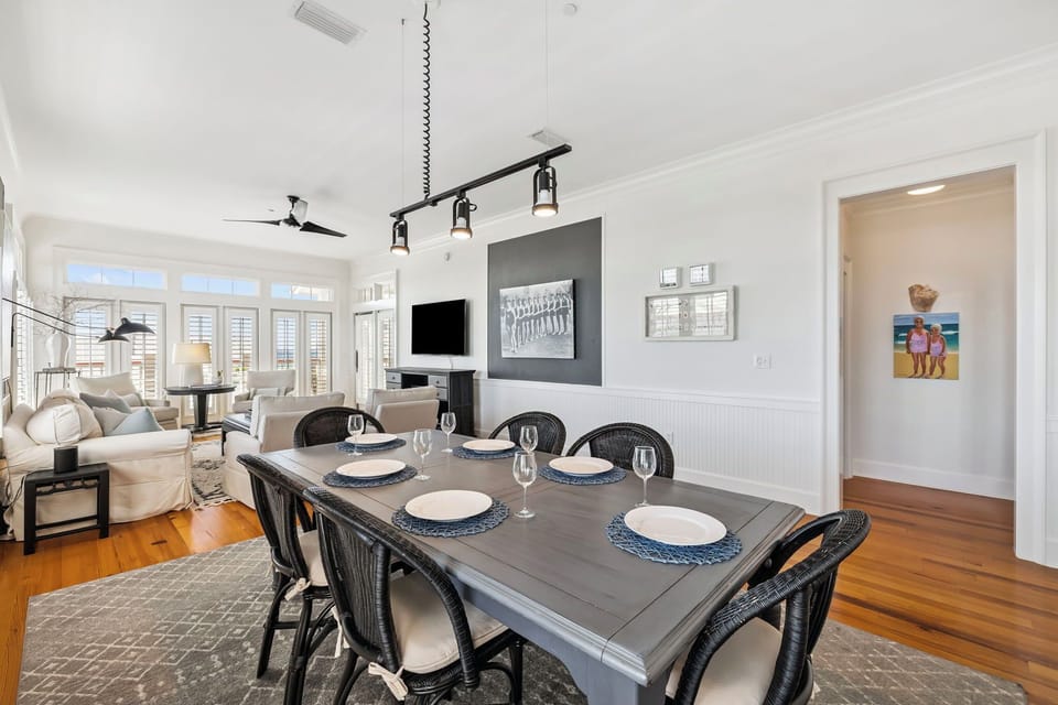 Your elegant dining space flows seamlessly into the living area, perfect for memorable meals with stunning natural light streaming through plantation shutters.