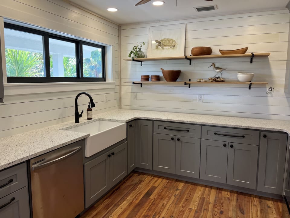 The kitchen has a large farmhouse sink, spacious counters & plenty of storage. 