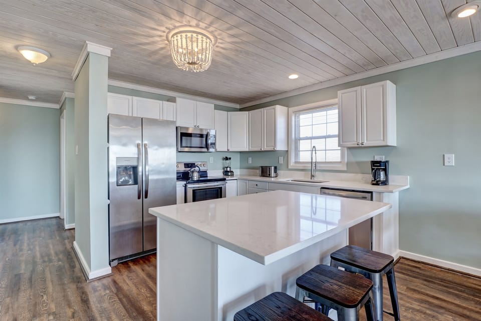 Kitchen with stainless steel appliances and quartz countertops
