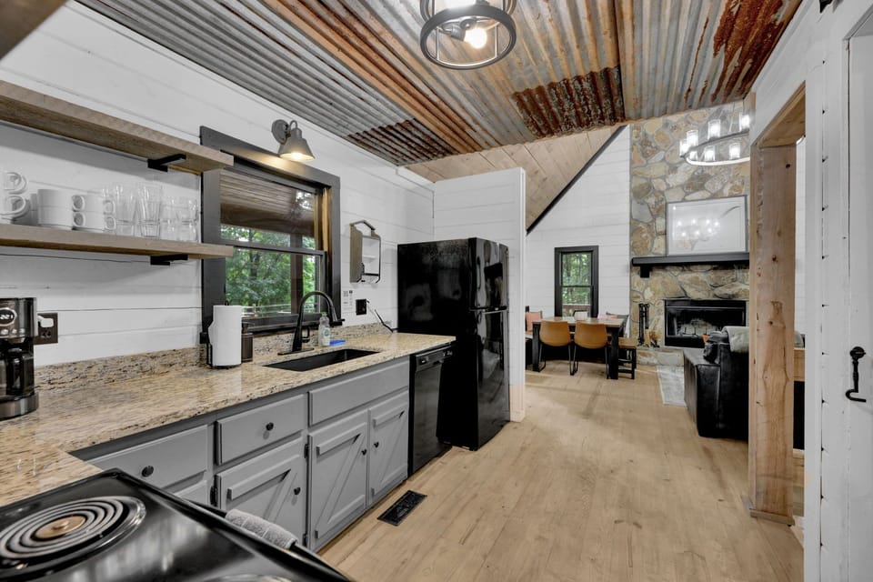 There is a toaster, blender, crock pot, bakeware, and pots & pans for meal prep.