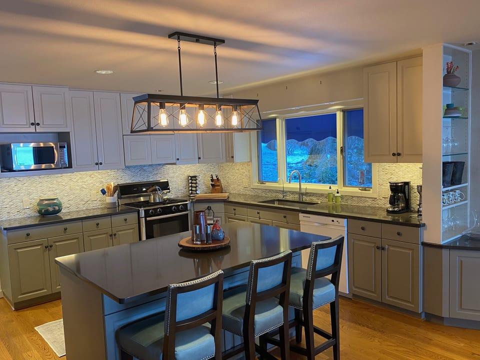 The newly renovated kitchen with garden and lake views, well-equipped.