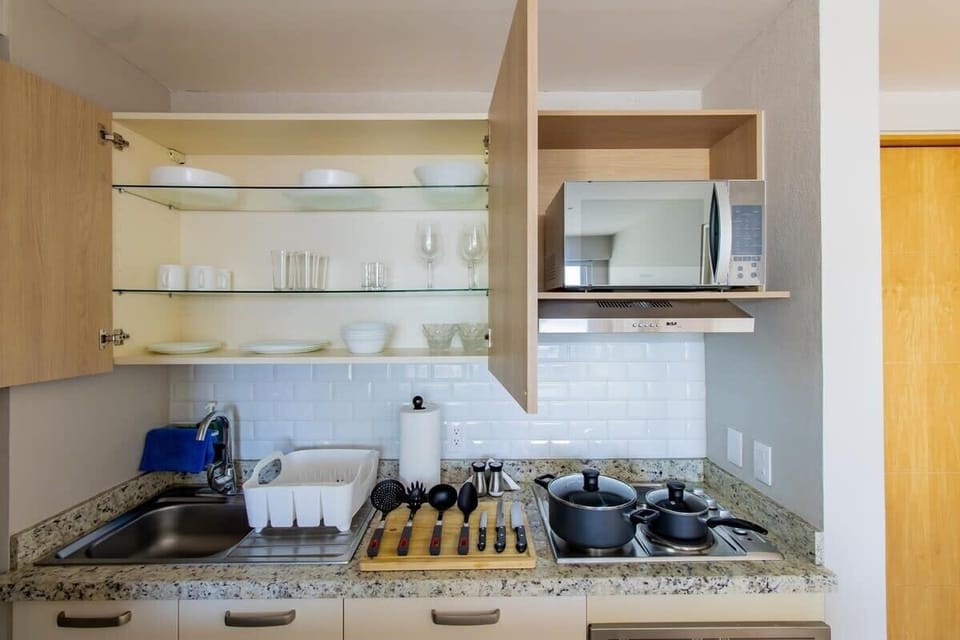 Fully equipped kitchen with appliances and utensils