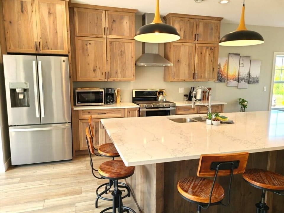 Waterfront rental with luxury kitchen, marble island, custom cabinets, and new appliances.