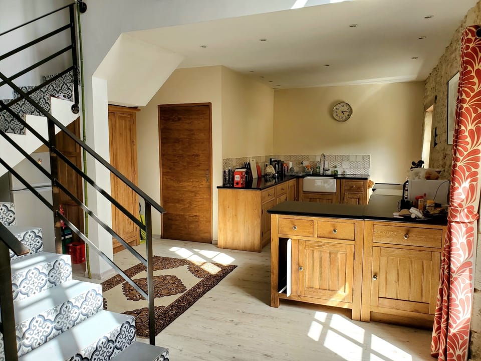 Kitchen showing larder cupboard, fridge/freezer and door to utility room