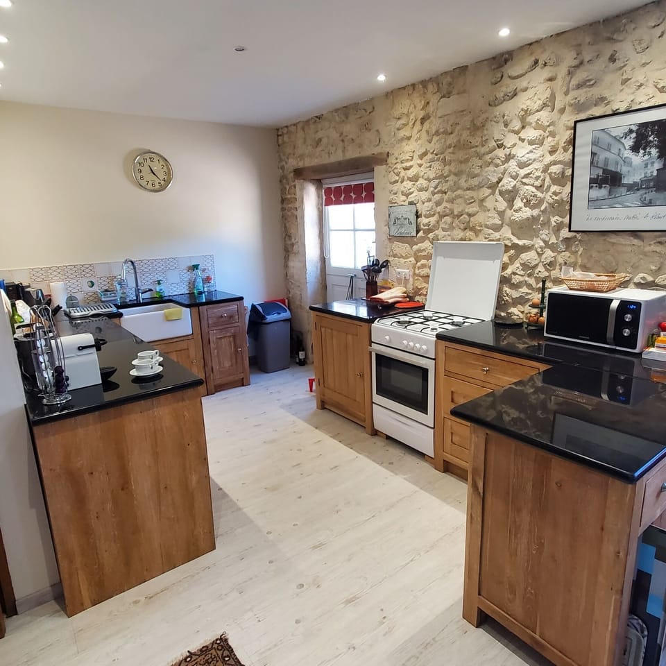 Kitchen showing gas cooker with oven and microwave