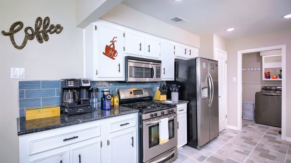 Wow! Look at this beautiful kitchen! Our kitchen is well equipped with stainless steel appliances, as well as smaller tools and utensils – including a rice cooker/Instapot, waffle maker, toaster, hand mixer, blender, coffee makers, and teapot.