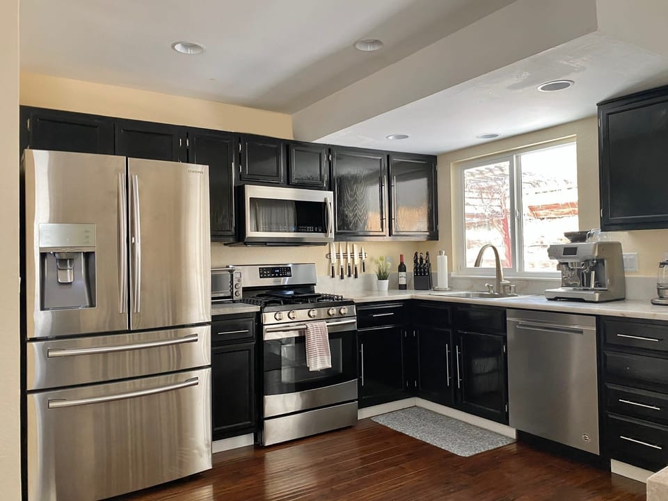 Enjoy preparing meals in this sleek, open kitchen with stainless steel appliances. 