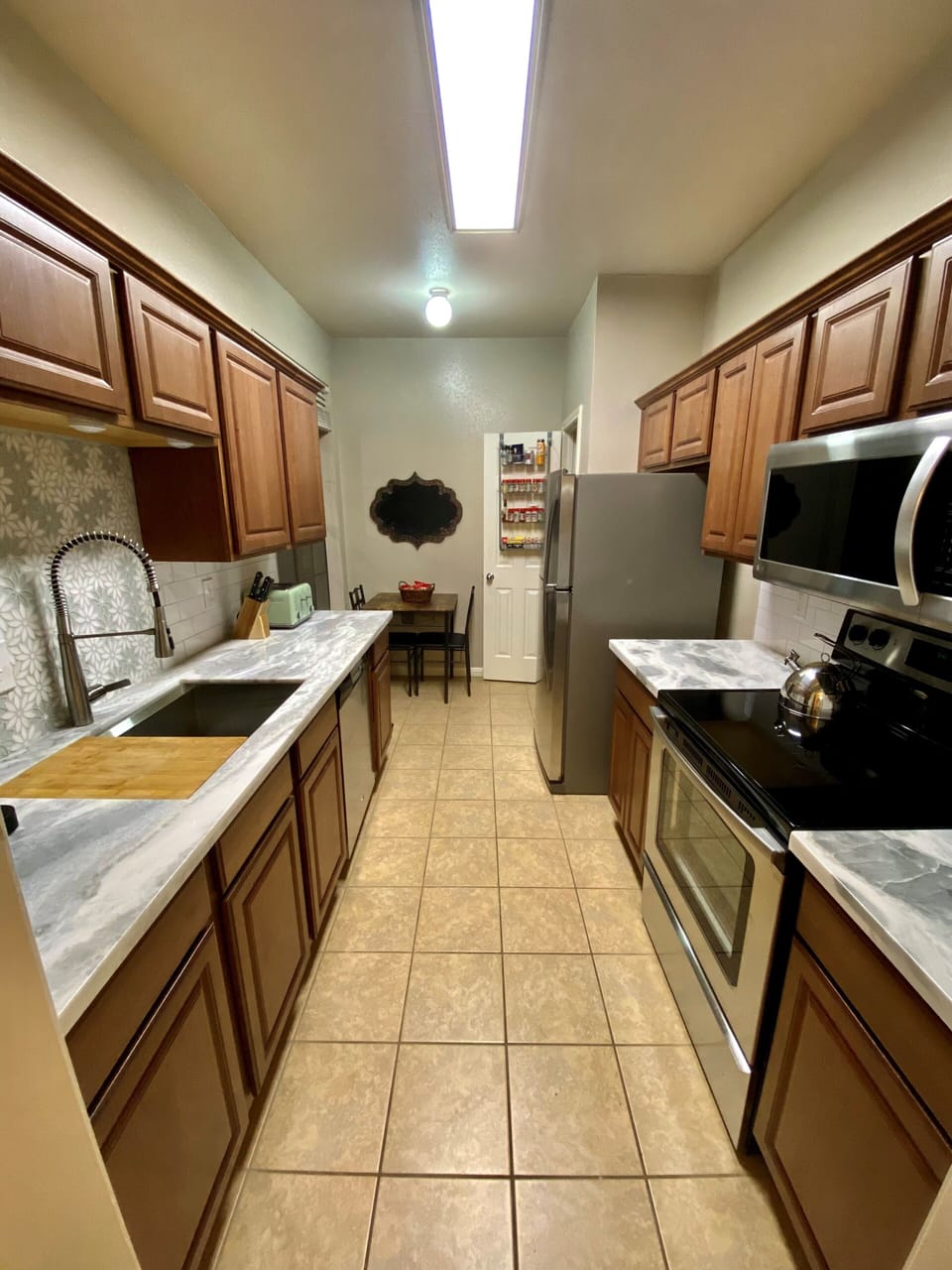 Beautiful quartzite counters with ample space and lots of cabinets and a pantry.