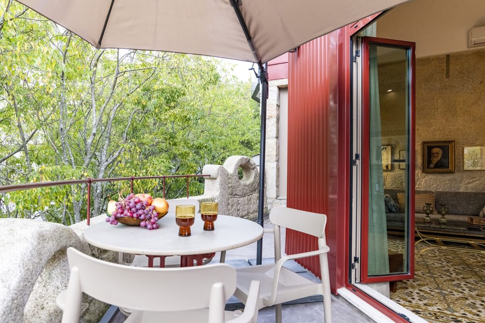 Sunny terrace facing the tall trees on the street 