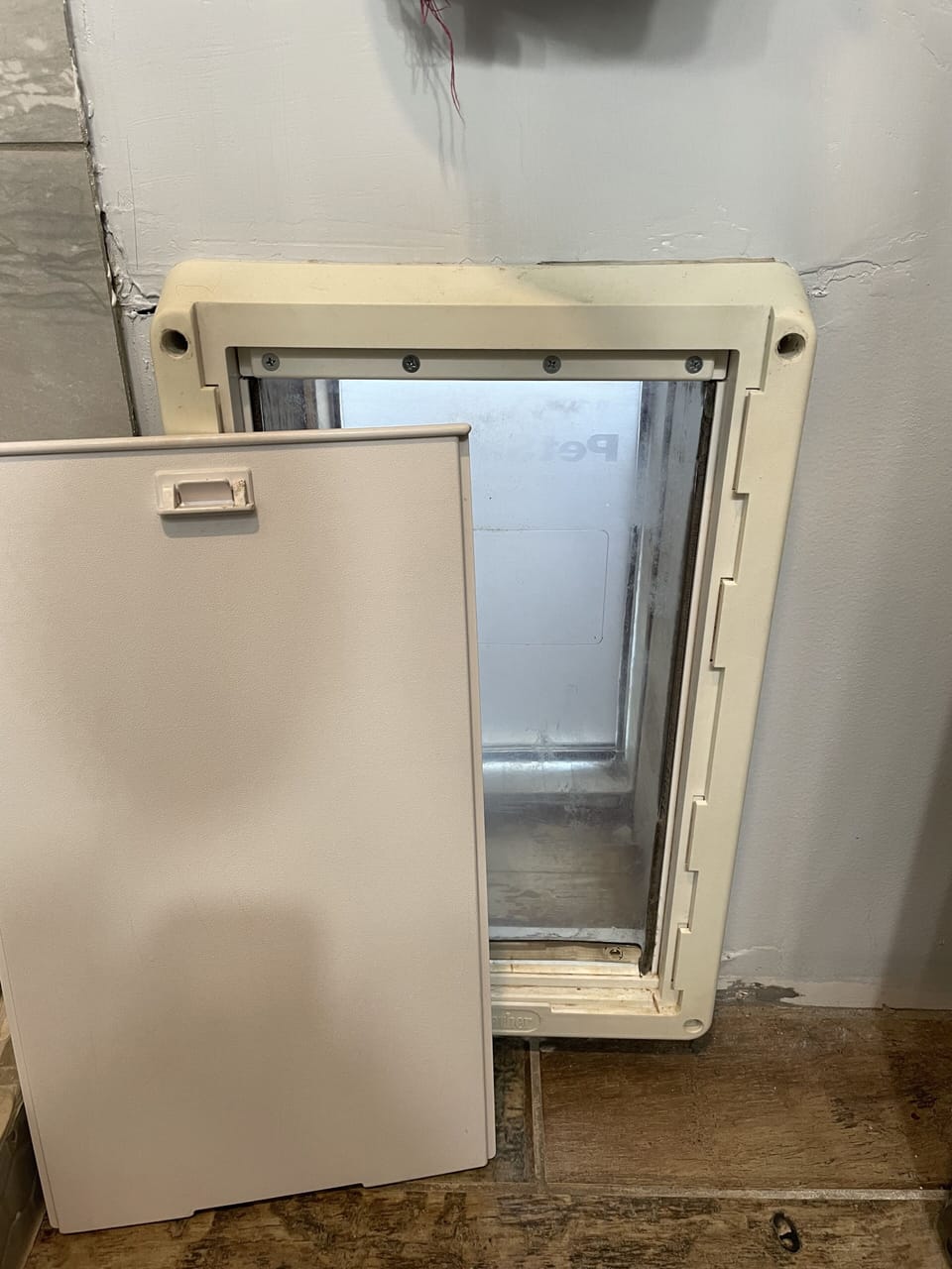 Pet door in bathroom leads to kennel and fenced run