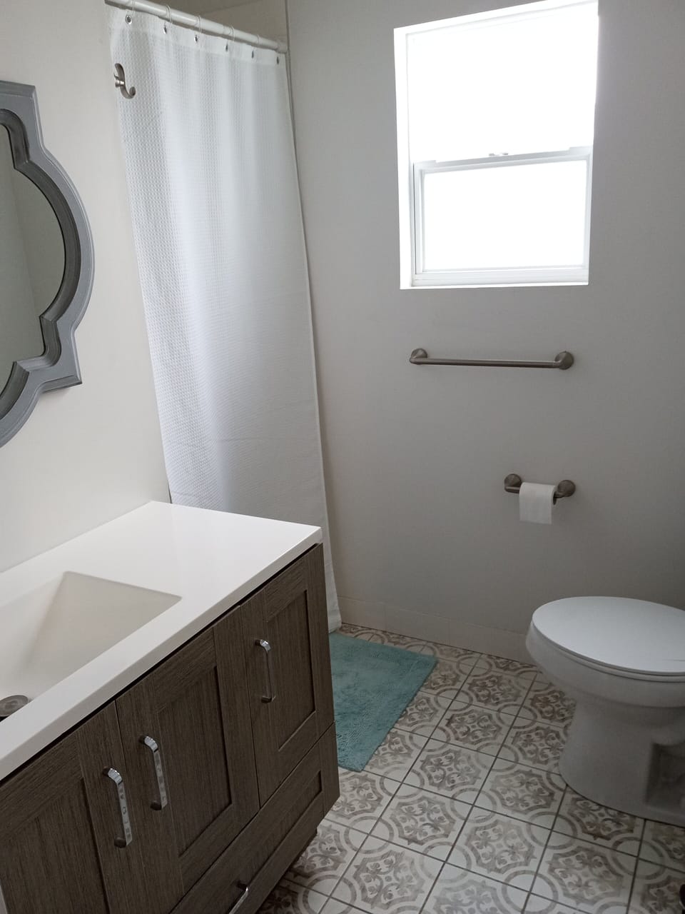 Bathroom 2 has toilet, sink, and low entry shower stall  - 1 1/2 inch high