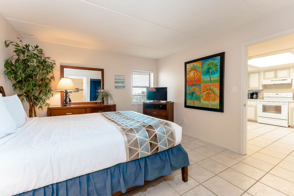 Our adorable guest bedroom has a cozy bed, flat screen TV, and lots of room to unpack and store the kids' toys.