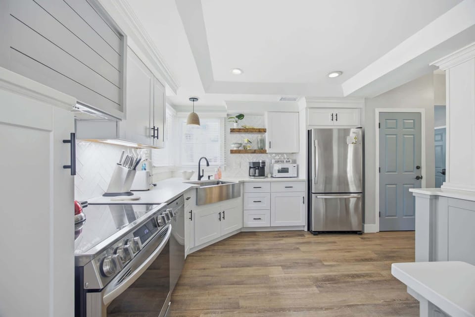 Modern kitchen with stainless steel appliances and farmhouse sink