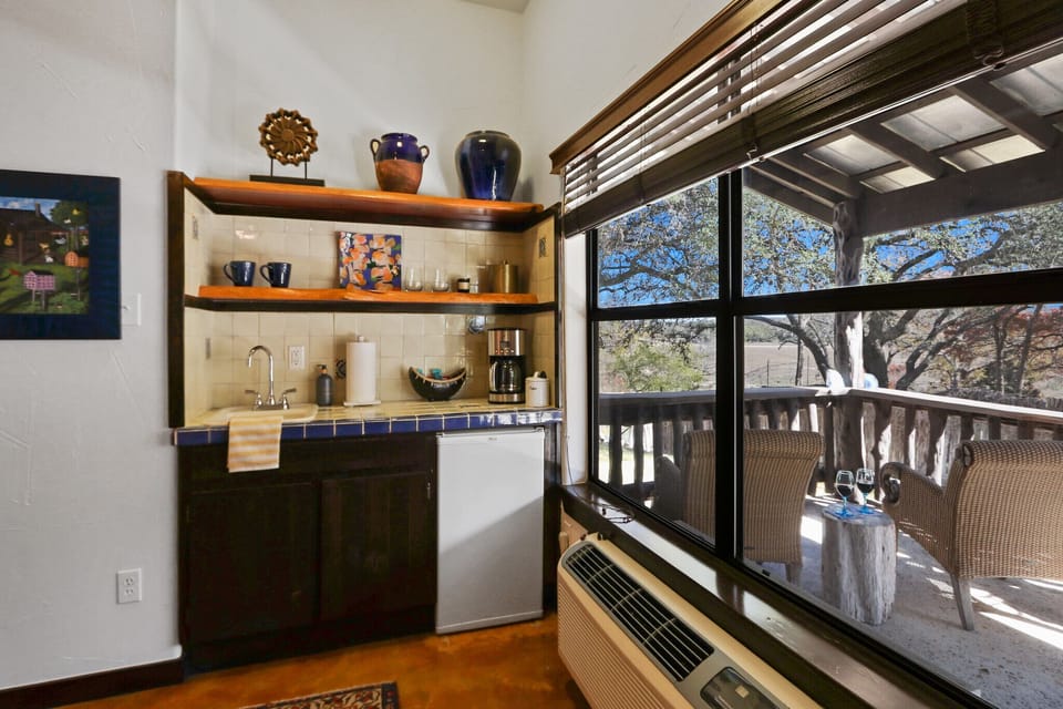 Kitchenette with a coffee maker, refrigerator, and sink