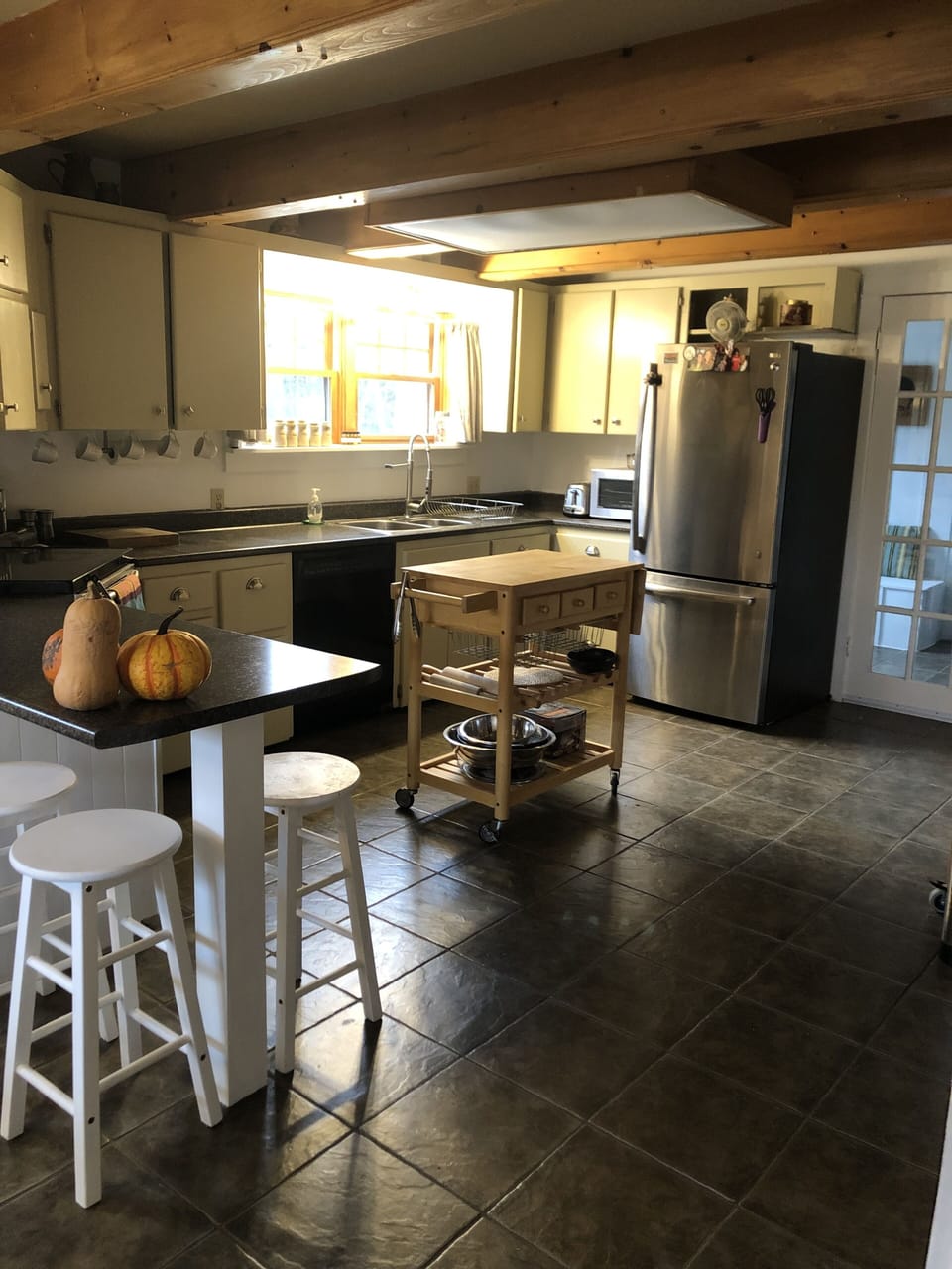 Spacious kitchen with large fridge and amenities.