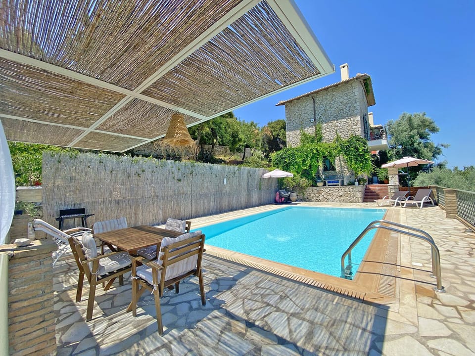 The pool and dining area of Villa Arion.