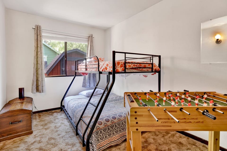 Peaceful cabin bedroom with plush bedding, and beautiful views—ideal for restful nights, cozy mornings, and a relaxing mountain escape.