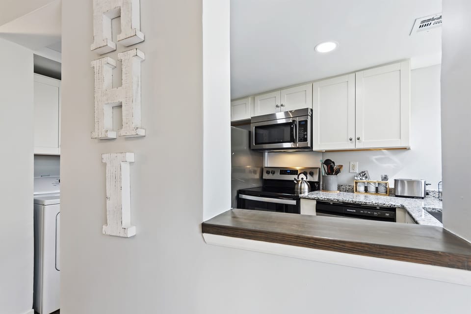 Theconvenient opening into the kitchen, ensuring you can effortlessly monitor the action while relaxing in the living room.