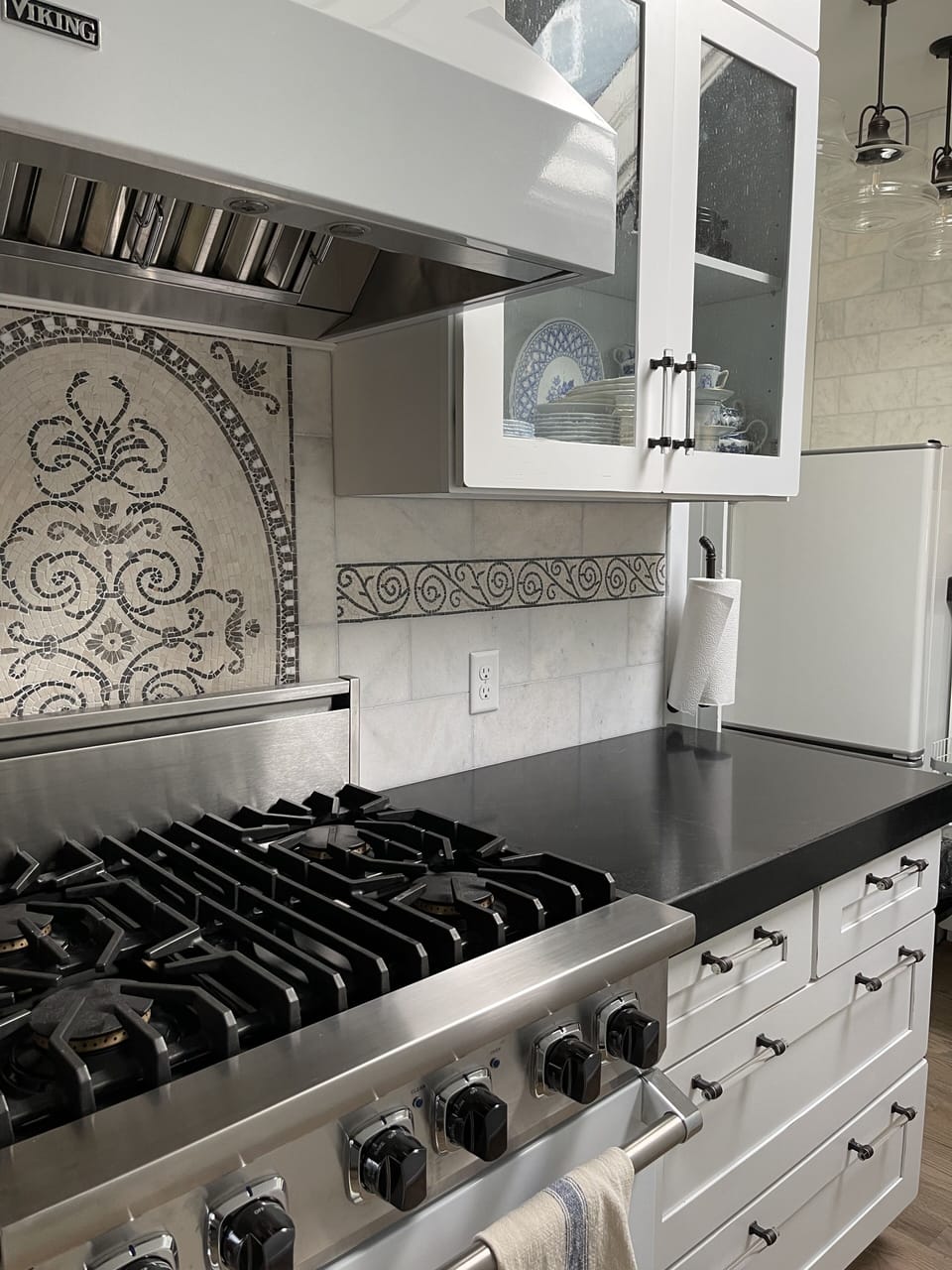 Our Viking gas range, black granite counters & marble mosaic are top notch!