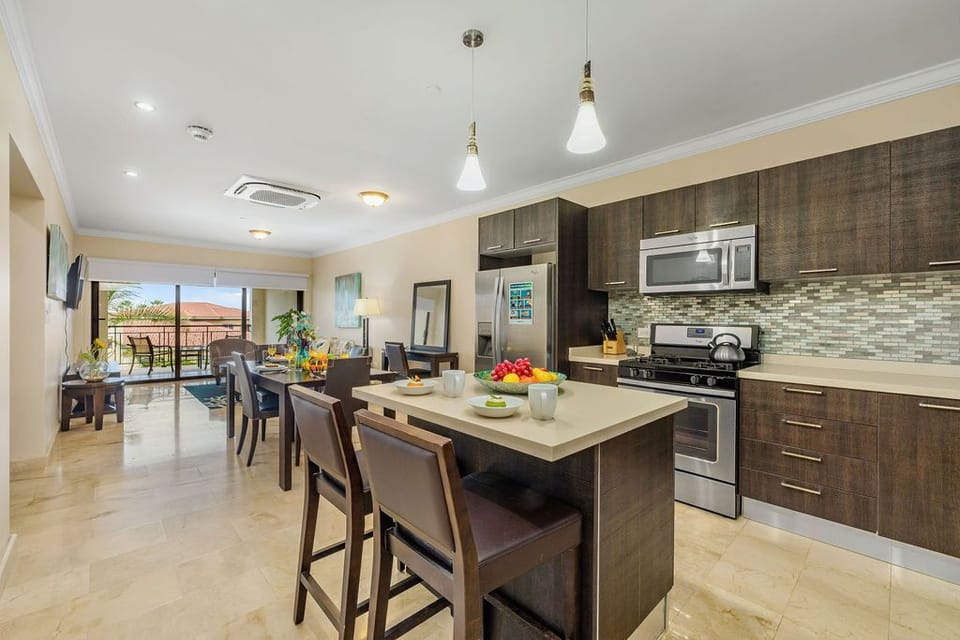 The fully equipped kitchen with kitchen counter and bar stool.