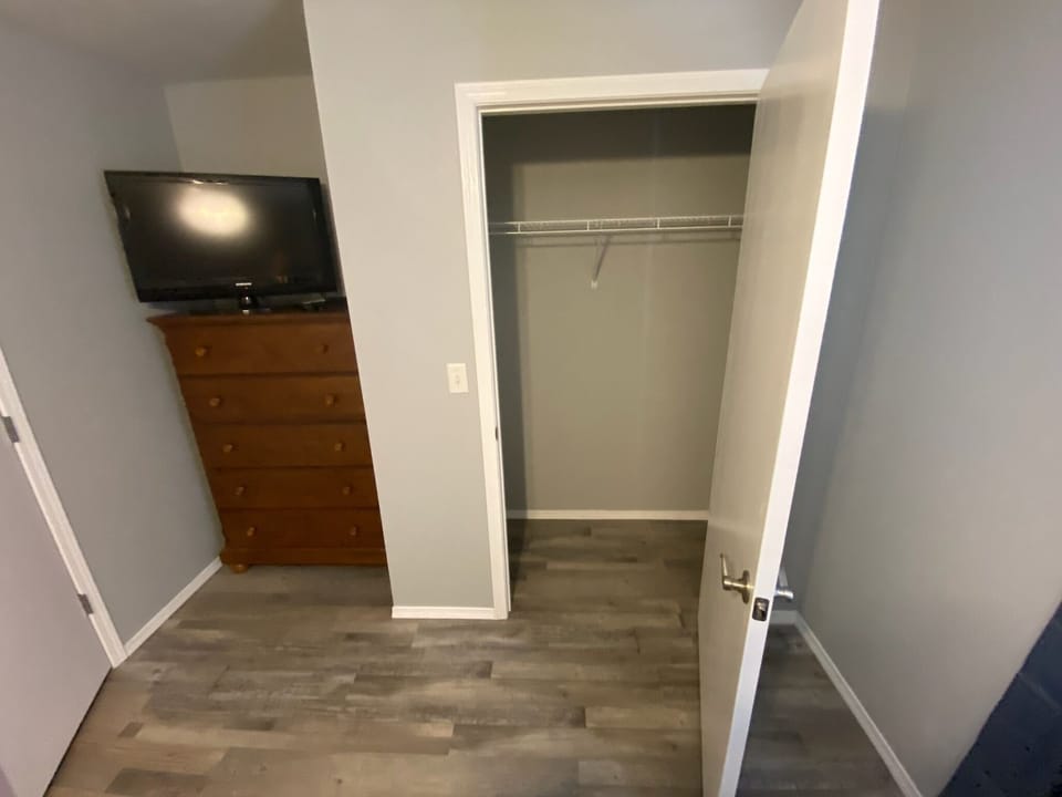 Television and closet in bedroom 2.