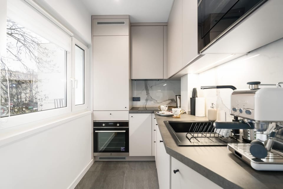 A modern kitchen with a sleek finish, complete with stainless steel appliances and ample counter space.

